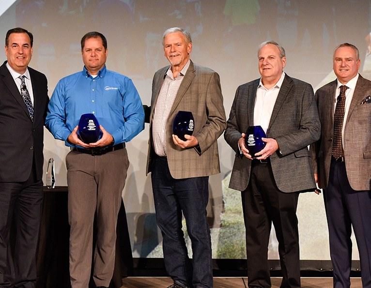 Men posing with awards