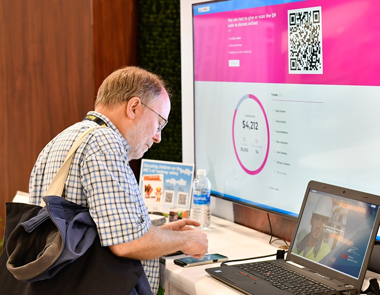 Man on computer pledge wall