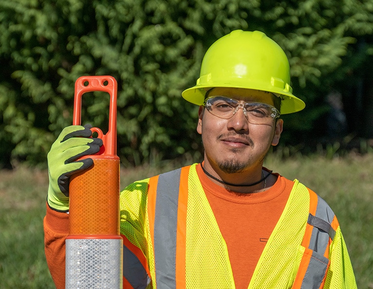 Worker with tall traffic cone