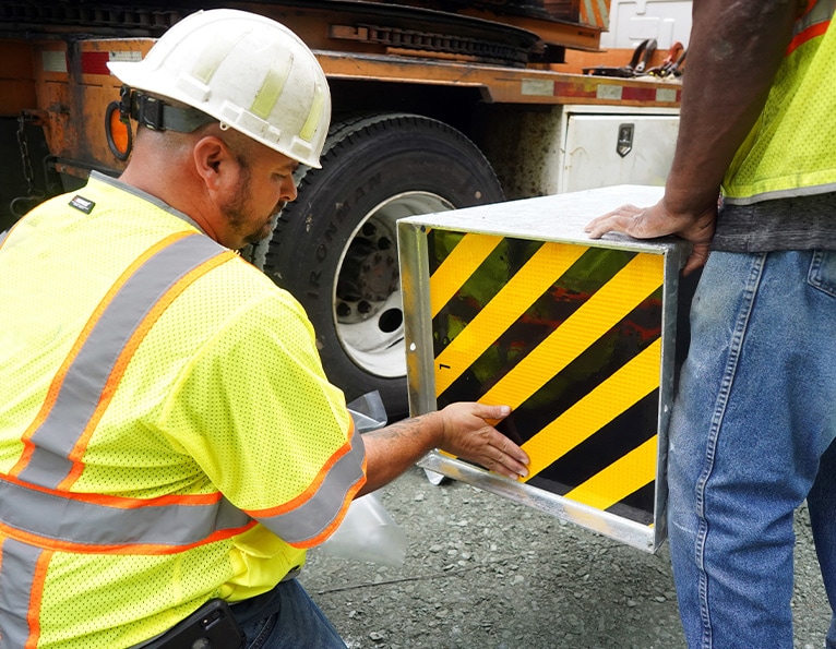 Worker installing guardrail