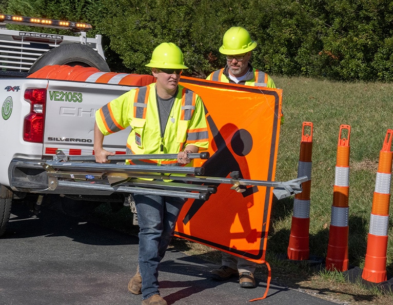 Worker setting up sign